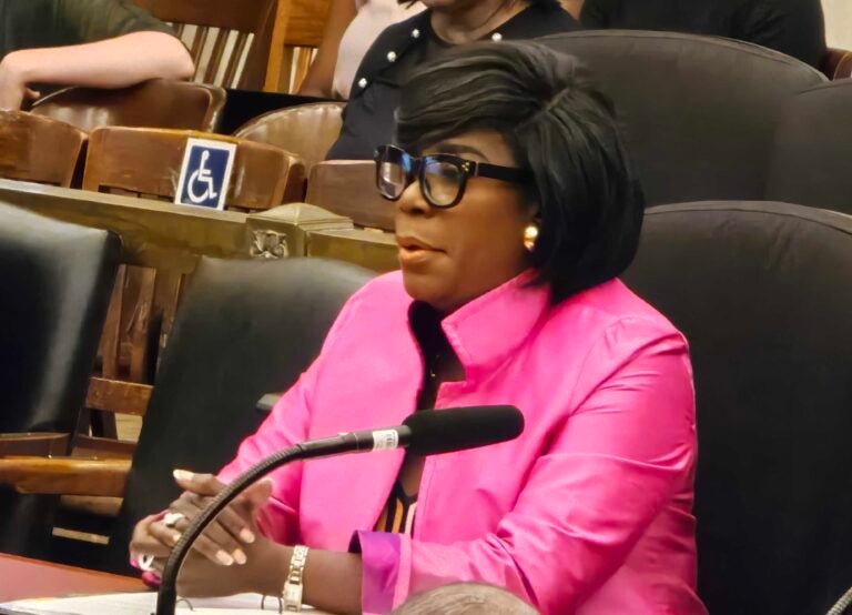 Cherelle Parker speaking into a microphone at a table