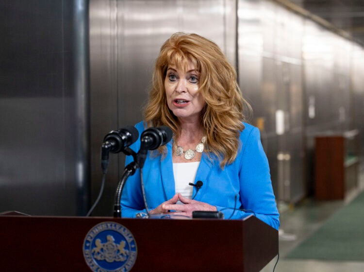 Stacy Garrity speaking at a podium