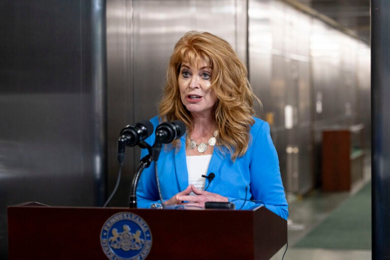 Stacy Garrity speaking at a podium