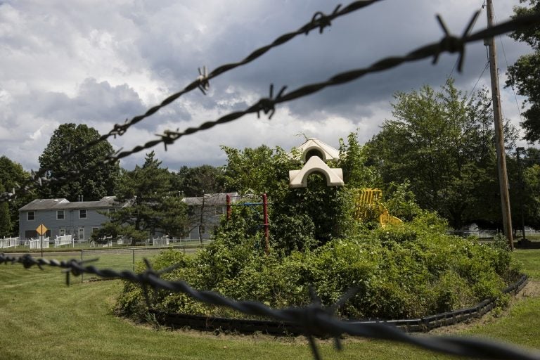 In this Aug. 1, 2018 photo weeds engulf a playground at housing section of the former Naval Air Warfare Center Warminster in Warminster, Pa. the foams once used routinely in firefighting training at military bases contained PFAS. (Matt Rourke/AP Photo)