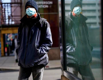 A person wearing a face mask walks in Philadelphia