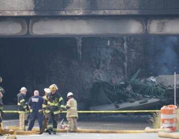 First responders work to extinguish a vehicle fire, Sunday June 11, 2023, that caused an overpass on I-95 to collapse near the Cottman Avenue exit