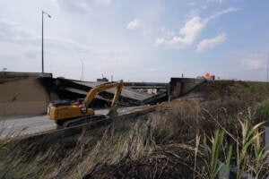 Crews work to remove rubble from a collapsed section of I-95, Sunday June 11, 2023, after a vehicle fire caused an overpass on I-95 to collapse near Cottman Avenue. (Joseph Kaczmarek for WHYY)