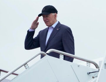 President Joe Biden salutes as he boards Air Force One