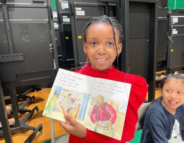 A young girl holding up her favorite book