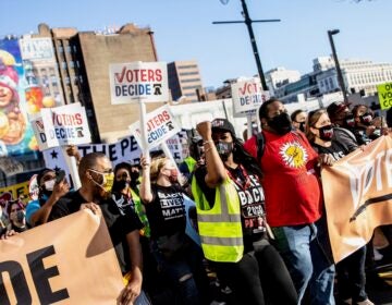 Demonstrators march through Center City Philadelphia to celebrate a Biden win