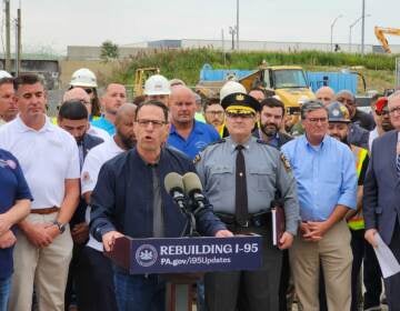 Josh Shapiro speaking at a podium at the collapse site.