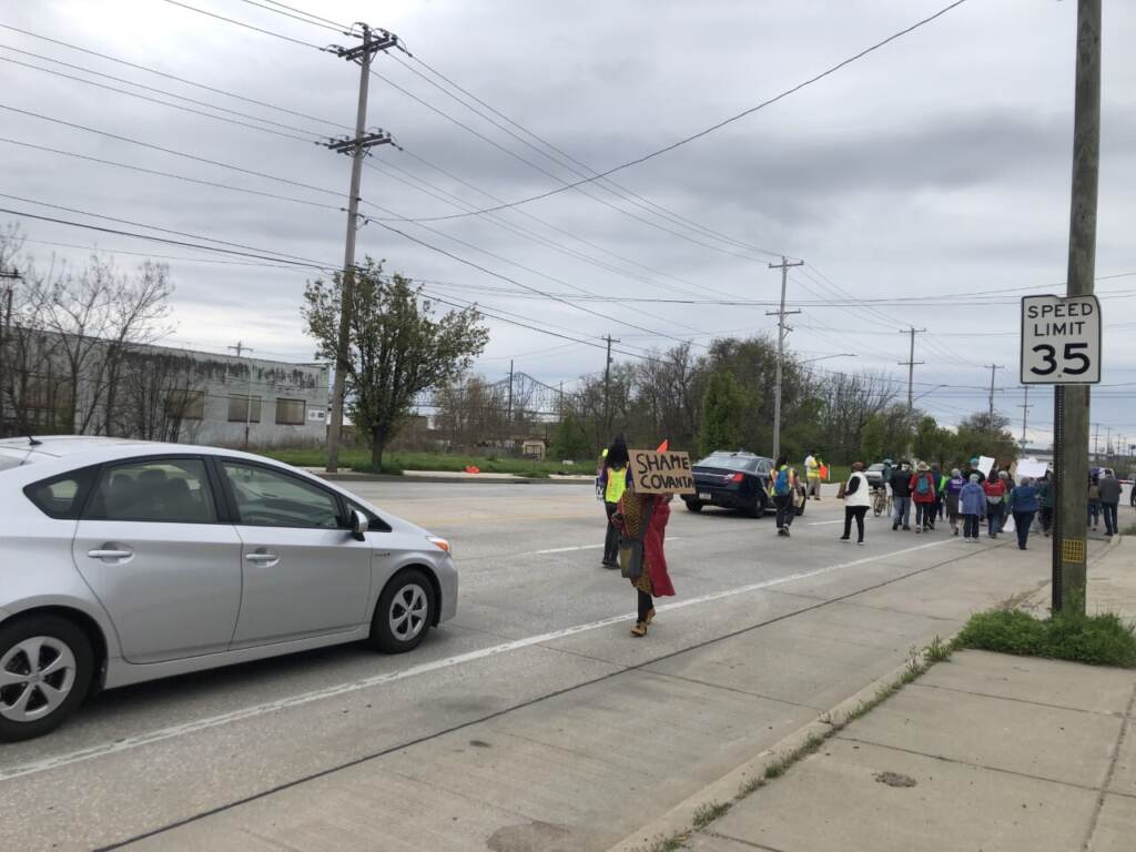 Protestors held signs like ''Shame Covanta'' as they marched from Chester City Hall to the Covanta incinerator along Pennsylvania Route 291. (Emily Rizzo/WHYY)