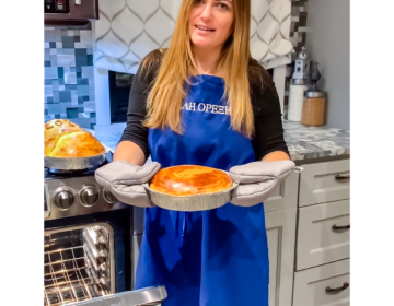 Culinary arts teacher Mrs. Mylonas shows a traditional Greek New Year's cake